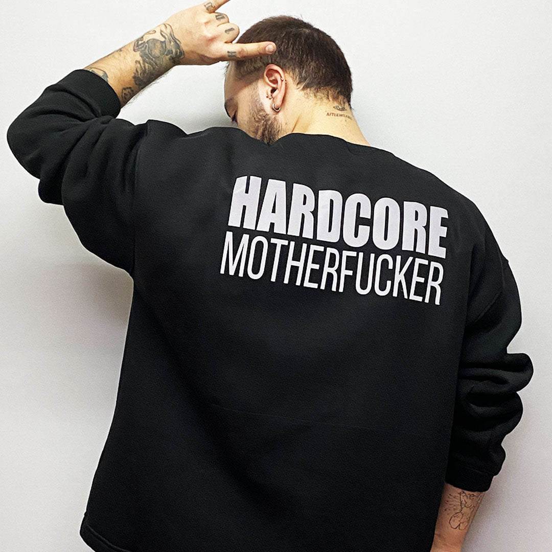 Unisex black oversize sweatshirt with 'HARDCORE MOTHERFUCKER' print, designed for rave lifestyle and techno party enthusiasts.