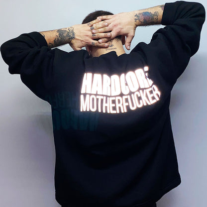 Unisex black oversize sweatshirt with 'HARDCORE MOTHERFUCKER' print, designed for rave lifestyle and techno party enthusiasts.